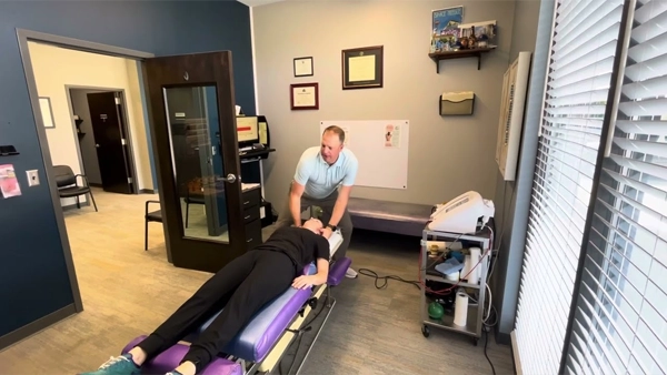 Chiropractor Sterling IL Brad Setchell Adjusting Patients Neck